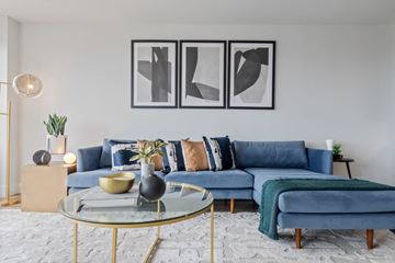 Chicago apartment for rent - a living room with blue couches and a glass coffee table