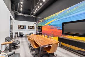 Chicago apartment for rent - a conference room with a large painting on the wall and a table with chairs