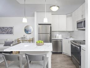 Chicago apartment for rent - White kitchen with marble island and stainless appliances at River North Park Apartments, Chicago, IL 60654