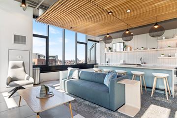 Chicago apartment for rent - A modern living room with a blue couch and a wooden coffee table.
