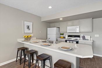 Fully-equipped kitchen with breakfast and bar stools