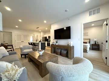 Henrietta townhouse for rent - A modern living room with a grey sofa and a wooden coffee table.