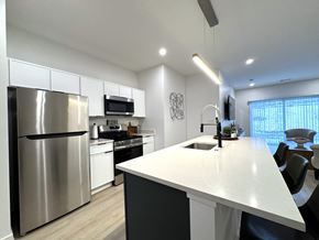 Henrietta townhouse for rent - View of typical kitchen with stainless steel appliances and breakfast bar overlooking the great room