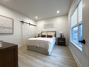Henrietta townhouse for rent - Typical primary bedroom with sliding barn door to en-suite bathroom & walk-in closet