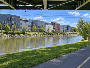 Pittsford apartment for rent - A river runs through a city with a bridge overhead and buildings on either side.