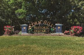 Rochester townhouse for rent - a sign for the coron hill historic district in front of a field of grass