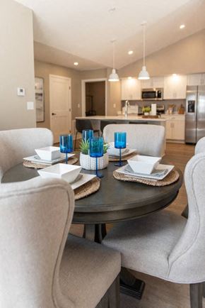 Victor townhouse for rent - Interior of Champion Reserve Townhomes dining area with kitchen and breakfast bar in the background.