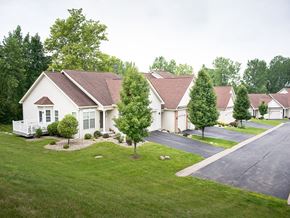 Webster townhouse for rent - a neighborhood of white houses on a street with green grass and trees