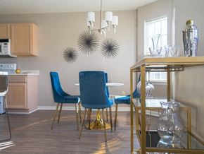 Webster townhouse for rent - a dining room with a table and chairs and a chandelier