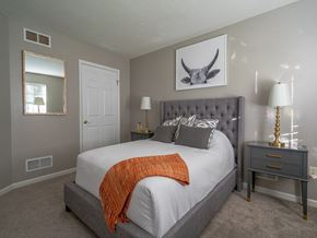 Webster townhouse for rent - a bedroom with a large bed and a mirror