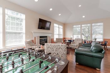 Webster woods' clubhouse with foosball table, fireplace, flat-screen tv, and kitchenette