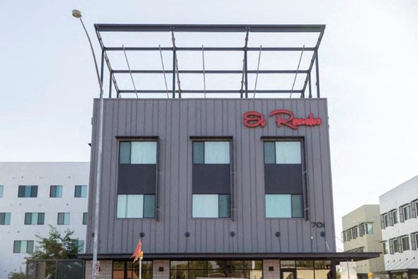Mesa apartment for rent - a gray building with a red sign on top of it