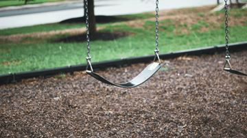Phoenix apartment for rent - an empty swing in a park next to the grass