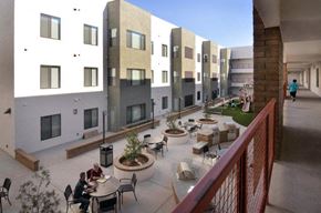 Mesa apartment for rent - people sitting at tables in a courtyard of a building