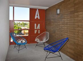 Mesa apartment for rent - two blue chairs on a porch next to a brick wall