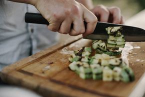 Glendale apartment for rent - a person cutting up cucumbers on a cutting board with a knife