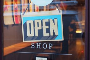 Tempe apartment for rent - a blue open shop sign in the window of a store