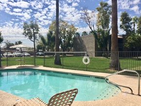 Phoenix apartment for rent - a swimming pool with chairs next to a fence