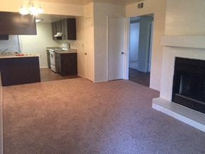 Phoenix apartment for rent - an empty living room with a fireplace and a kitchen