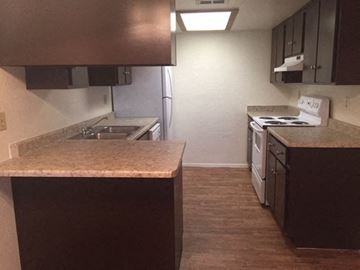 Phoenix apartment for rent - an empty kitchen with a stove and a sink