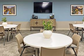 Phoenix apartment for rent - a conference room with tables and chairs and a television on the wall