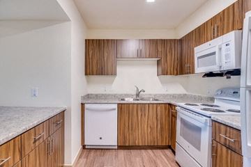 Phoenix apartment for rent - A kitchen with wooden cabinets and white appliances.