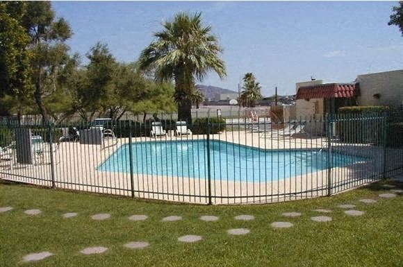 Phoenix apartment for rent - a swimming pool is behind a wrought iron fence