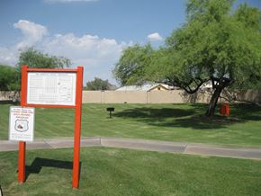 Phoenix apartment for rent - a sign in a park next to a tree