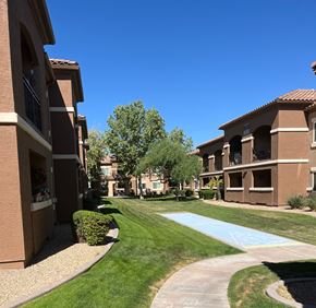 Sun City West apartment for rent - A sunny day at a residential complex with a clear blue sky.