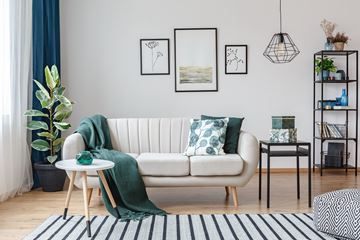 Glendale apartment for rent - a living room with a white couch and green pillows
