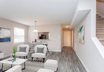 Raleigh townhouse for rent - A living room with a grey carpet and white furniture.