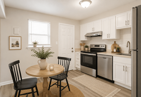 Charlotte apartment for rent - A kitchen with a table and chairs in the foreground and a refrigerator, oven, and microwave in the background.