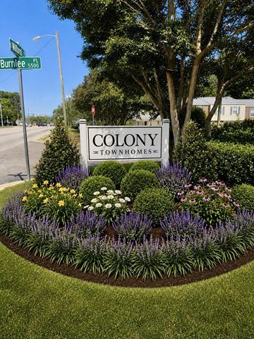 Raleigh townhouse for rent - A sign for Colony Townhomes is surrounded by a flower bed.
