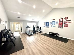 Durham apartment for rent - A gym with a variety of equipment including treadmills, weights, and exercise machines.