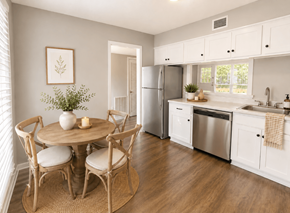 Raleigh townhouse for rent - A kitchen with a table and chairs in the foreground and a refrigerator in the background.