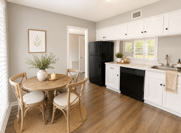 Raleigh townhouse for rent - A kitchen with a round table and chairs, a black refrigerator, and a window with blinds.