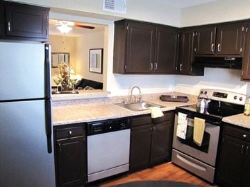 Raleigh townhouse for rent - a kitchen with stainless steel appliances and black cabinets
