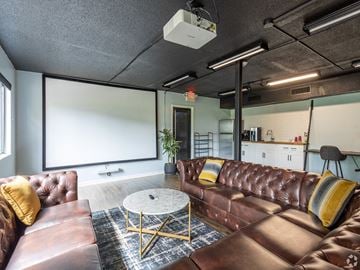 Raleigh apartment for rent - a living room with leather couches and a coffee table