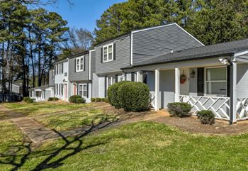 A row of houses with a green lawn in front  at greenwood village