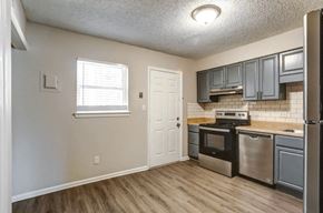 Charlotte apartment for rent - Kitchen and living room with lights at Greenwood Village, Charlotte