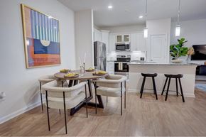 Concord apartment for rent - A kitchen with a dining table and chairs.at Evolve at Parkway Apartment Homes, Concord, 28027