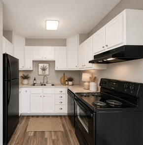 Charlotte apartment for rent - A black stove in a kitchen with white cabinets.