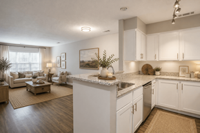 Durham apartment for rent - A kitchen with white cabinets and a marble countertop.