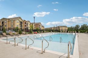 Lebanon apartment for rent - A large swimming pool surrounded by a metal railing and apartment buildings in the background at Venue at 109 Apartments, Tennessee, 37090