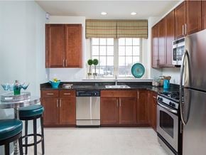 Hillsborough apartment for rent - A kitchen with wooden cabinets and a black countertop.