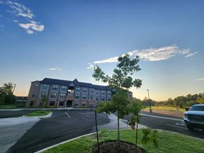 Claremore apartment for rent - A large building with a parking lot in front of it.