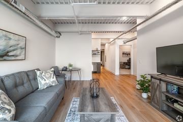 Lancaster apartment for rent - A living room with a grey couch and a glass coffee table.