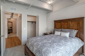 Lancaster apartment for rent - A bedroom with a large bed and a wooden headboard.