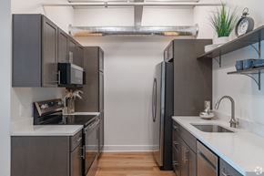 Lancaster apartment for rent - A modern kitchen with dark grey cabinets and stainless steel appliances.