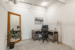 Lancaster apartment for rent - A room with a desk, chair, and a painting on the wall.